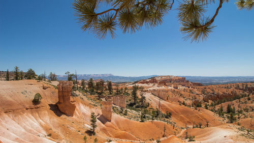 Scenic view of desert against blue sky