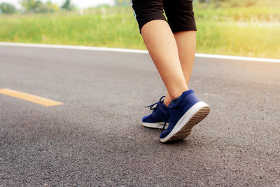 Low section of woman on road