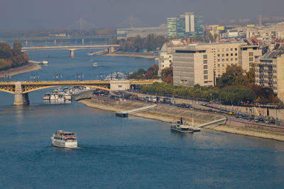 Bridge over river by buildings in city