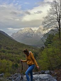 Female hiker hiking against mountains