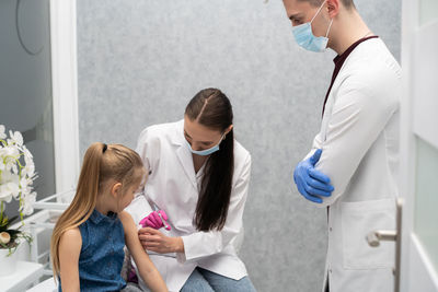 Female doctor examining patient at clinic