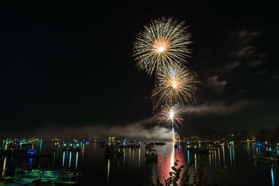 Low angle view of firework display against sky at night