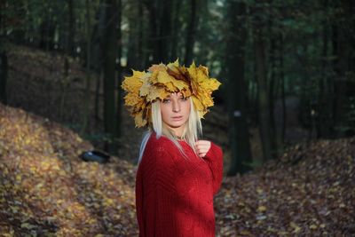 Woman standing by yellow flowers during autumn