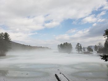 Scenic view of snow covered land against sky