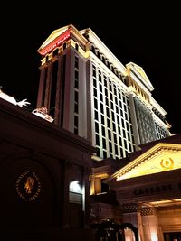 Low angle view of illuminated building at night