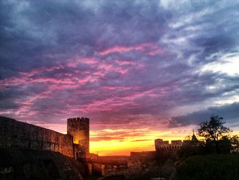 Built structure against cloudy sky at sunset