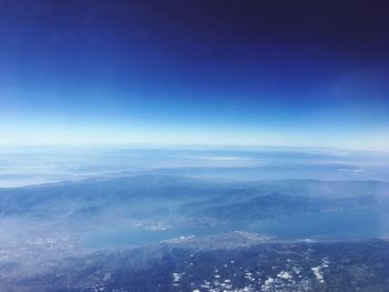 Aerial view of landscape against blue sky