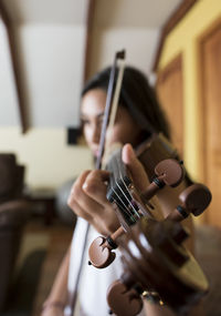 Midsection of woman playing guitar