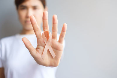 Cropped hand gesturing against white background