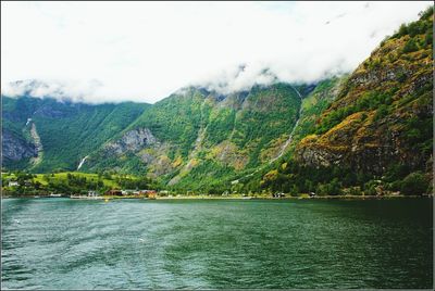 Scenic view of lake against cloudy sky