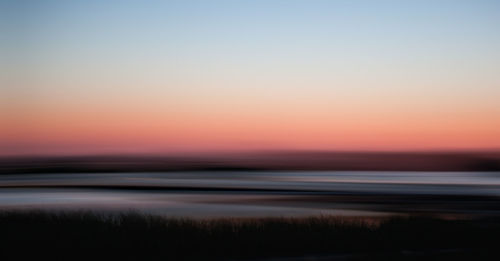 Scenic view of sea at sunset