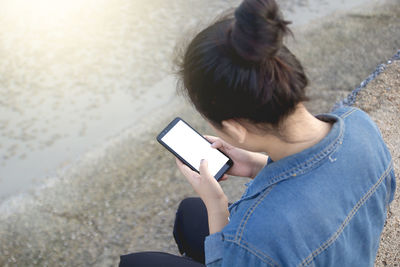 High angle view of senior woman using mobile phone