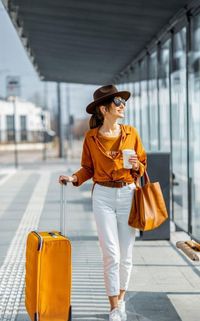 Side view of woman standing in city