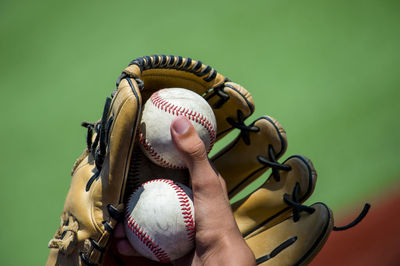 Cropped hand holding baseball ball