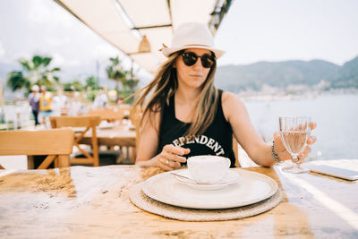 Portrait of woman wearing sunglasses on table