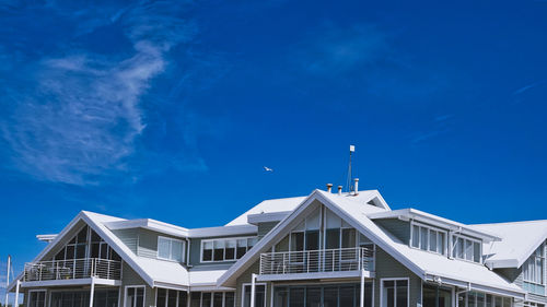 Low angle view of buildings against blue sky