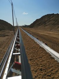 Surface level of railroad tracks against sky