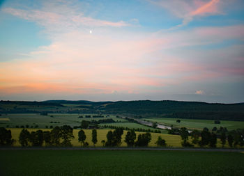 Scenic view of field against sky during sunset