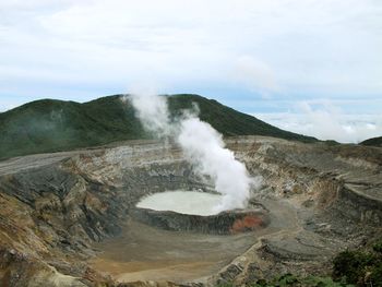 High angle view of volcanic crater against sky