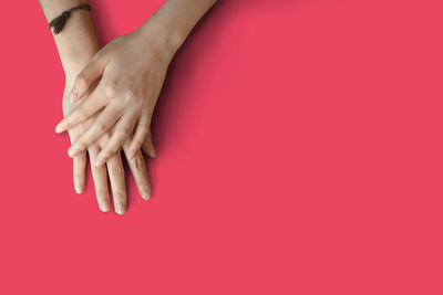 Close-up of woman hand on red background