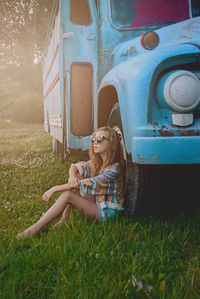 Portrait of a young woman sitting on grass