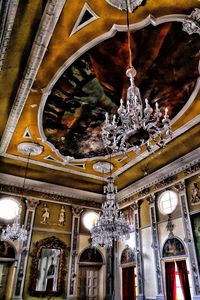 Low angle view of illuminated chandelier hanging in building