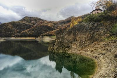 Scenic view of lake and mountains against sky