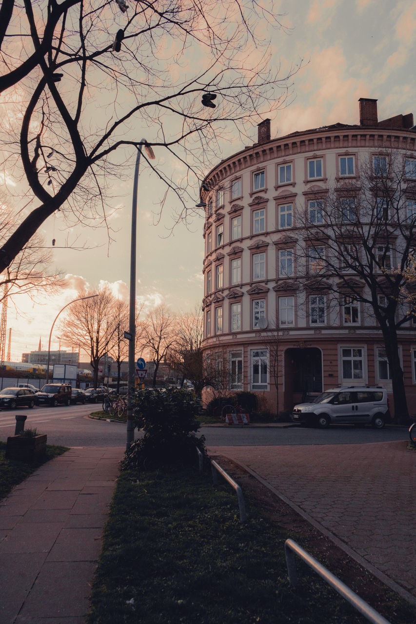 STREET BY BUILDING AGAINST SKY