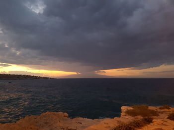 Scenic view of sea against cloudy sky