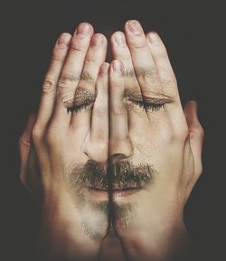 Close-up of hands over black background