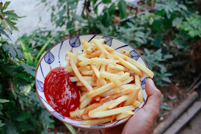 Cropped hand of person holding food