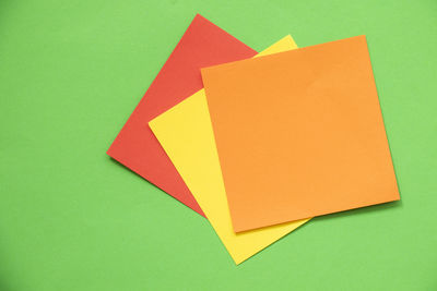 High angle view of paper on yellow background