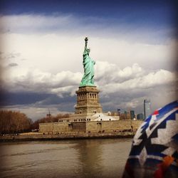 Statue of liberty against cloudy sky