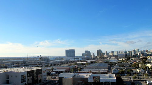 View of cityscape against blue sky