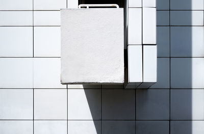 Close-up of tiled floor against white wall