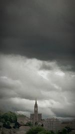 Buildings against cloudy sky