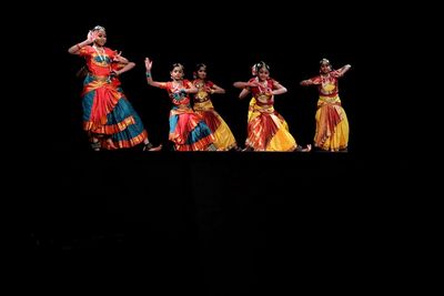 High angle view of people dancing against black background