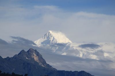 Scenic view of mountains against cloudy sky