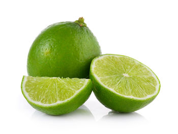 Close-up of green fruit against white background