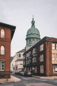Street amidst buildings against clear sky