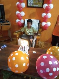 Portrait of smiling girl with balloons