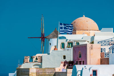 The national flag of greece on the island of santorini.