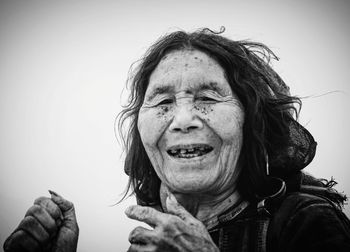 Portrait of smiling woman against sky