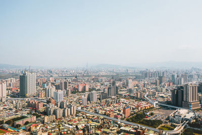 High angle view of modern buildings in city against clear sky