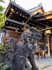 Statue of temple against building