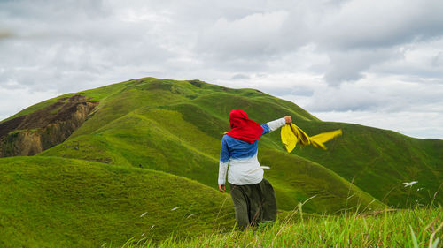 Man standing on mountain against sky