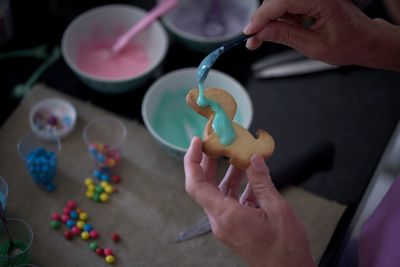 High angle view of person preparing cookies on table