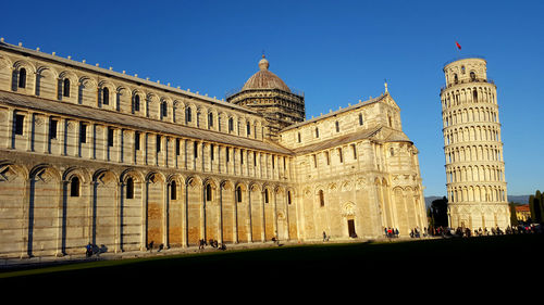 Low angle view of historical building against clear blue sky