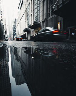 Reflection of cars on road in city