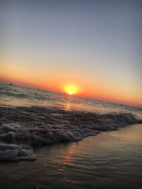 Scenic view of sea against clear sky during sunset